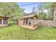 Charming shed featuring ample windows and a door, creating a bright and inviting space in the backyard at 6401 N Oakland Ave, Indianapolis, IN 46220