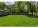 Lush green backyard featuring a wooden fence and plenty of space at 7770 N Pennsylvania St, Indianapolis, IN 46240