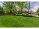 Expansive, green backyard featuring a wooden fence and mature trees at 7770 N Pennsylvania St, Indianapolis, IN 46240