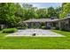 Expansive backyard with an in-ground pool covered by a safety net, mature trees at 7770 N Pennsylvania St, Indianapolis, IN 46240
