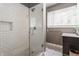 Modern bathroom featuring a tiled walk-in shower with glass door and updated vanity at 7770 N Pennsylvania St, Indianapolis, IN 46240