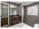 Elegant bathroom with stained glass window in tiled shower, and vanity at 7770 N Pennsylvania St, Indianapolis, IN 46240