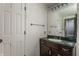 Bathroom with vanity and green marble top. A bright light fixture sits over a vanity mirror at 7770 N Pennsylvania St, Indianapolis, IN 46240