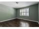Bright bedroom with dark hardwood floors, neutral walls, and plantation shutters at 7770 N Pennsylvania St, Indianapolis, IN 46240