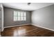 Cozy bedroom featuring hardwood floors and a window with white shutters at 7770 N Pennsylvania St, Indianapolis, IN 46240