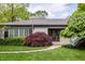Close-up of a home's front entrance with a decorative tree, walkway and manicured lawn at 7770 N Pennsylvania St, Indianapolis, IN 46240