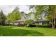 Well maintained single-story home featuring lush lawn, mature trees, and a serene setting at 7770 N Pennsylvania St, Indianapolis, IN 46240