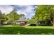 Inviting single-story home with a well-manicured lawn and mature trees at 7770 N Pennsylvania St, Indianapolis, IN 46240