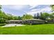 Spacious backyard features a fenced in in-ground pool with an outdoor lounging area at 7770 N Pennsylvania St, Indianapolis, IN 46240