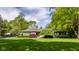 Beautiful single-story home features a well-manicured lawn, mature trees and tasteful landscaping at 7770 N Pennsylvania St, Indianapolis, IN 46240