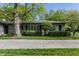 Charming single-story home featuring a well-manicured lawn and lush landscaping at 7770 N Pennsylvania St, Indianapolis, IN 46240