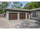 Attached two-car garage with updated doors and adjacent driveway at 7770 N Pennsylvania St, Indianapolis, IN 46240