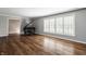 Bright living room featuring hardwood floors, large windows with shutters and grey paint at 7770 N Pennsylvania St, Indianapolis, IN 46240