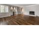 Spacious living room featuring custom cabinets and fireplace with dark wood flooring at 7770 N Pennsylvania St, Indianapolis, IN 46240