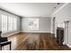 Living room featuring hardwood floors, fireplace, large windows, and neutral wall colors at 7770 N Pennsylvania St, Indianapolis, IN 46240