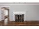 Elegant living room with a white fireplace, hardwood floors, and neutral paint at 7770 N Pennsylvania St, Indianapolis, IN 46240