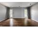 Open living room with beautiful hardwood floors and French doors leading to the outside at 7770 N Pennsylvania St, Indianapolis, IN 46240