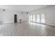 Bright living room with tile flooring, white walls, and access to the backyard at 7770 N Pennsylvania St, Indianapolis, IN 46240