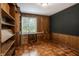 Cozy office with wood paneling, built-in shelving, and a vintage feel at 7770 N Pennsylvania St, Indianapolis, IN 46240