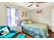 This bedroom boasts a ceiling fan, a plush accent chair, and a view to the outdoors at 8145 Bentley Farms Dr, Indianapolis, IN 46259