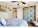Bedroom with closet with blue distressed sliding doors, ceiling fan, and wood-look floors at 8145 Bentley Farms Dr, Indianapolis, IN 46259