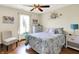 Charming bedroom featuring a decorative floral wall design, comfortable bed, and soft natural light at 8145 Bentley Farms Dr, Indianapolis, IN 46259