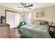 Charming bedroom features a bed, dresser with television, and a plush teal chair at 8145 Bentley Farms Dr, Indianapolis, IN 46259