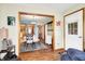 Open-concept dining area with hardwood floors, wood trim, and views into the kitchen and living spaces at 8145 Bentley Farms Dr, Indianapolis, IN 46259