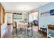 Inviting dining room featuring blue accent walls, a round table with seating for four, and stylish decor at 8145 Bentley Farms Dr, Indianapolis, IN 46259