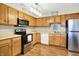 Spacious kitchen highlighting stainless steel appliances, light wood cabinetry, and a convenient layout at 8145 Bentley Farms Dr, Indianapolis, IN 46259