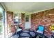 Covered patio features brick walls, outdoor seating, and views of the yard at 8145 Bentley Farms Dr, Indianapolis, IN 46259