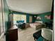 Comfortable bedroom with vibrant green walls, a desk, and a large window overlooking a leafy view at 8507 Promontory Rd, Indianapolis, IN 46236