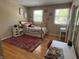 Bedroom features a cozy bed, a colorful rug, and plenty of natural light from two windows at 8507 Promontory Rd, Indianapolis, IN 46236