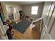 Cozy room with hardwood floors, a gray patterned rug, and a white saucer chair at 8507 Promontory Rd, Indianapolis, IN 46236