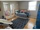 Inviting bedroom with hardwood floors, stylish decor, and a view into the connected room through glass doors at 8507 Promontory Rd, Indianapolis, IN 46236