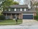 Charming two-story home with brick accents, a covered porch, and well-maintained landscaping at 8507 Promontory Rd, Indianapolis, IN 46236
