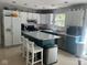 Well-equipped kitchen with an island, white cabinetry, and stainless steel appliances at 8507 Promontory Rd, Indianapolis, IN 46236
