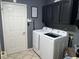 Practical laundry room equipped with a washer and dryer, plus storage cabinets at 8507 Promontory Rd, Indianapolis, IN 46236