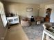 Cozy living room featuring neutral tones, comfortable seating, and natural light from a large window at 8507 Promontory Rd, Indianapolis, IN 46236
