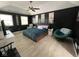 Spacious main bedroom featuring dark accent walls, a ceiling fan, and neutral flooring at 8507 Promontory Rd, Indianapolis, IN 46236