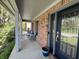 Cozy front porch with seating, brick facade, and charming curb appeal at 8507 Promontory Rd, Indianapolis, IN 46236