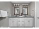 Modern bathroom with double vanity, framed mirrors, and contemporary lighting fixtures at 863 N Park Trail Dr, Carmel, IN 46032
