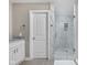 Contemporary bathroom featuring a glass-enclosed shower, white cabinets, and modern fixtures at 863 N Park Trail Dr, Carmel, IN 46032