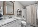 Bright bathroom featuring a marble vanity top, modern fixtures, and a shower with a decorative curtain at 863 N Park Trail Dr, Carmel, IN 46032