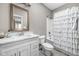 Clean bathroom featuring a vanity with stone countertop and a shower with a ruffled curtain at 863 N Park Trail Dr, Carmel, IN 46032