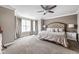 Spacious bedroom featuring plush carpet, a large bed, and a bay window with natural light at 863 N Park Trail Dr, Carmel, IN 46032
