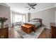 Serene bedroom with hardwood floors, a cozy bed, and large windows offering natural light at 863 N Park Trail Dr, Carmel, IN 46032