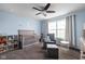 Bright Bedroom featuring a gray crib, a comfy chair, and soft blue walls at 863 N Park Trail Dr, Carmel, IN 46032