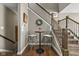 Charming foyer with seating area, dark wood floors, staircase and modern fixtures at 863 N Park Trail Dr, Carmel, IN 46032
