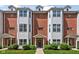 Charming townhome with brick facade, complemented by manicured landscaping and a welcoming front entrance at 863 N Park Trail Dr, Carmel, IN 46032